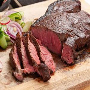 Grilling meat on charcoal barbecue